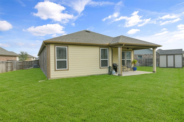 rear view of house featuring a shed, central AC unit, a patio area, and a lawn