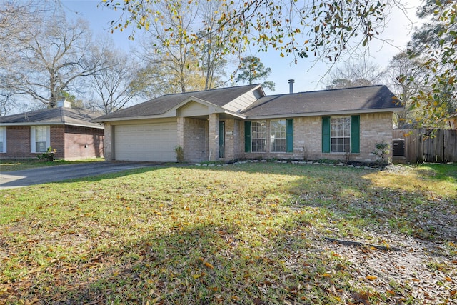 ranch-style house featuring a garage and a front lawn