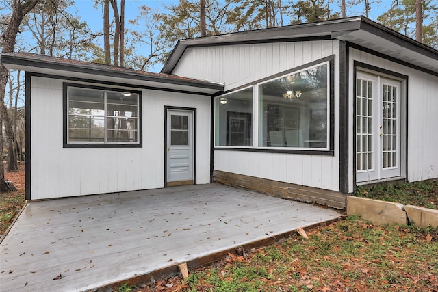 back of house with a wooden deck and french doors