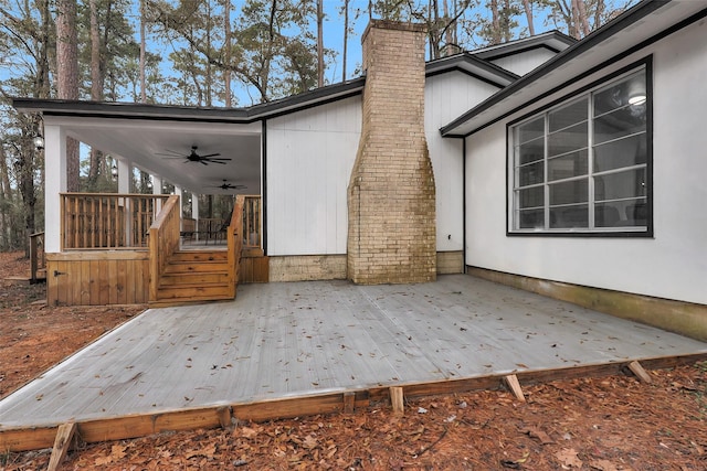 view of home's exterior with ceiling fan and a deck