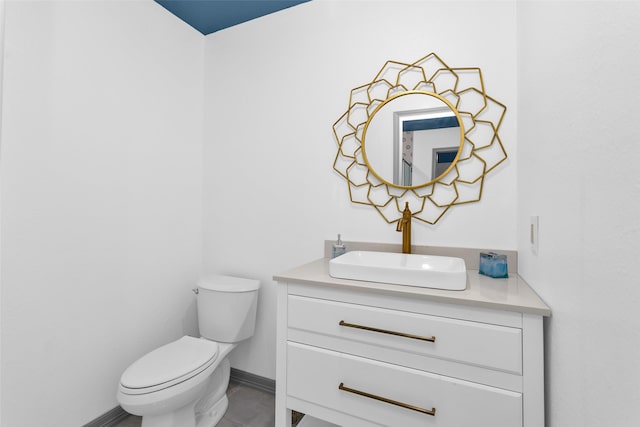 bathroom featuring tile patterned floors, vanity, and toilet