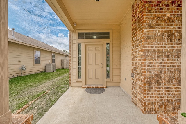 doorway to property with a patio and central AC