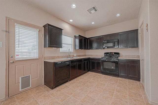 kitchen with dark brown cabinets, sink, and black appliances