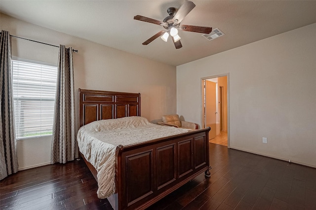 bedroom with dark hardwood / wood-style floors and ceiling fan