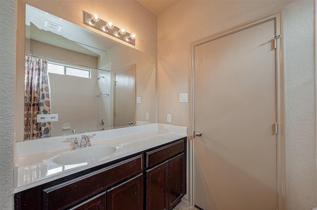 bathroom featuring vanity and shower / bath combo