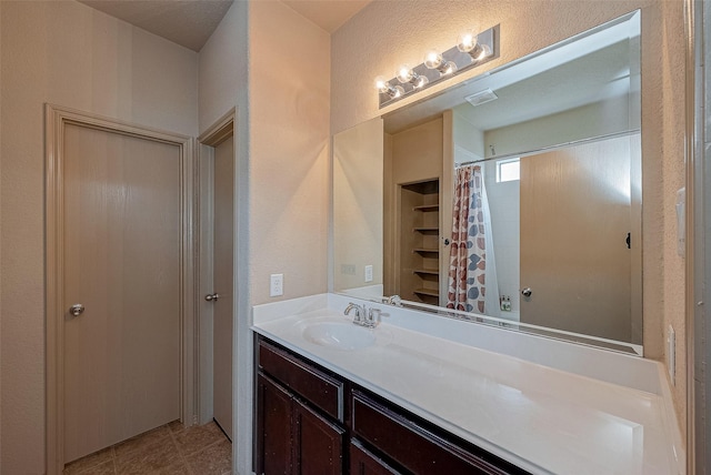 bathroom with vanity, tile patterned floors, and a shower with shower curtain