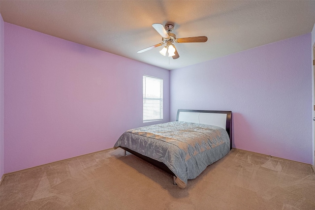 bedroom featuring light carpet and ceiling fan