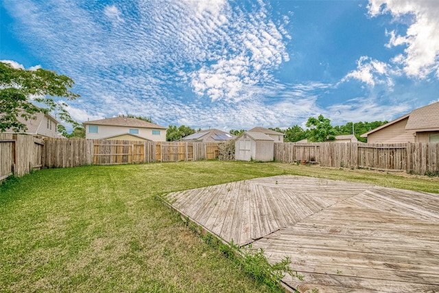 view of yard with a storage unit and a deck