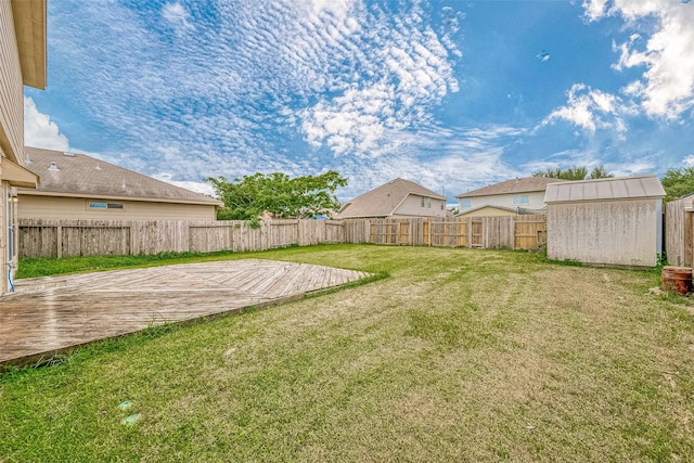 view of yard featuring a shed and a wooden deck