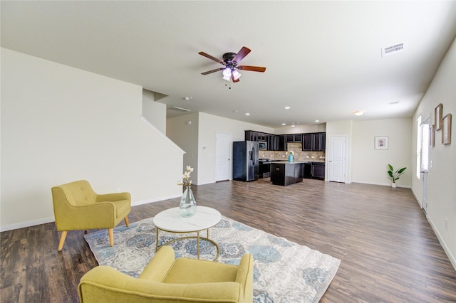 living room with dark wood-type flooring and ceiling fan