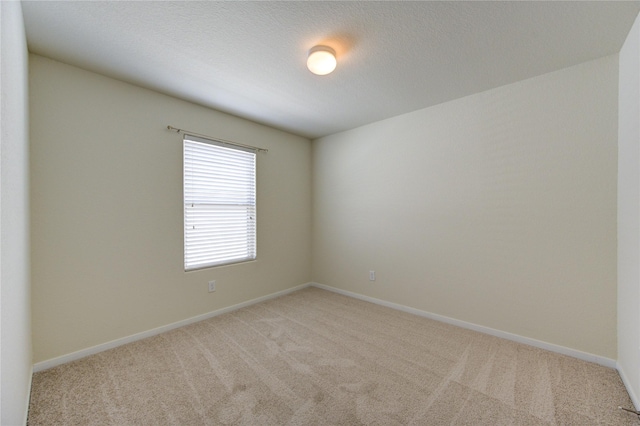 carpeted spare room featuring a textured ceiling