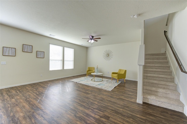 unfurnished room with ceiling fan, dark hardwood / wood-style floors, and a textured ceiling