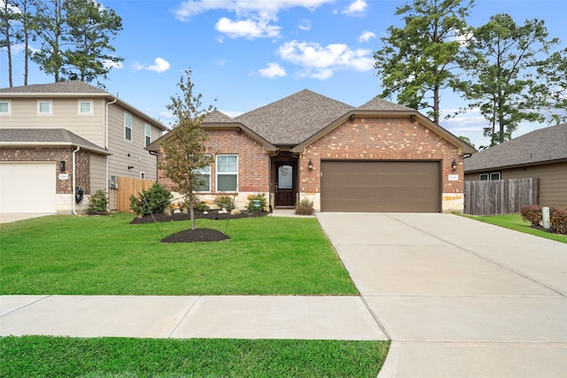 view of front of property with a garage and a front yard