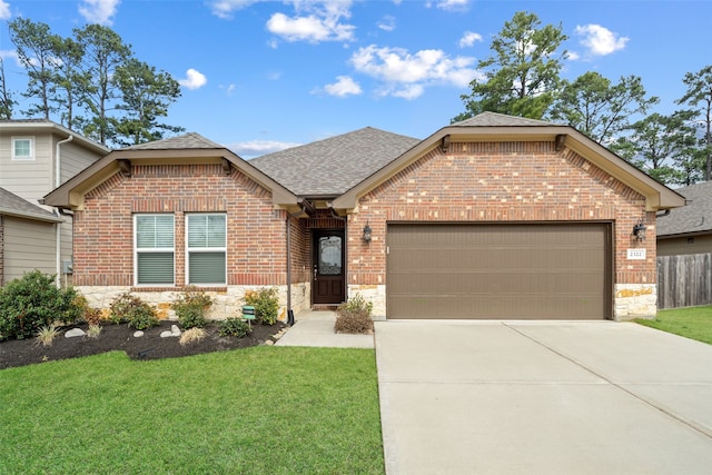 view of front of home with a garage and a front yard