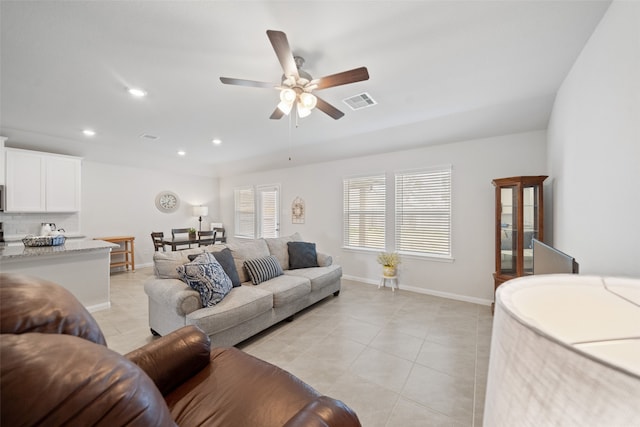 tiled living room featuring ceiling fan