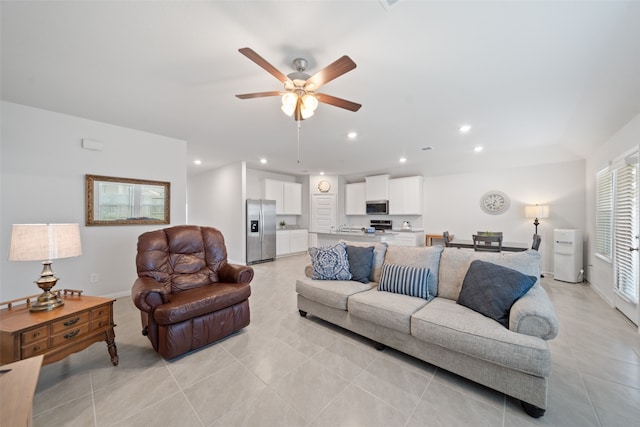 living room featuring light tile patterned floors and ceiling fan