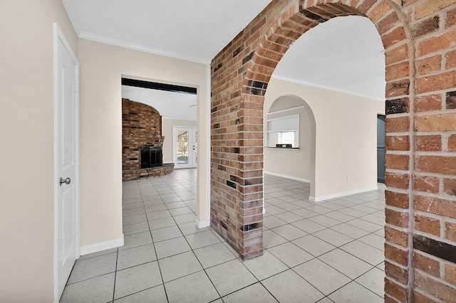 corridor with light tile patterned floors, a wealth of natural light, and ornamental molding