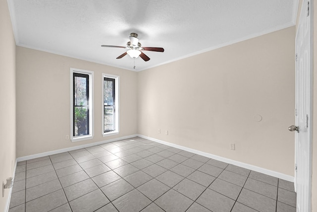 tiled empty room with ceiling fan, ornamental molding, and a textured ceiling