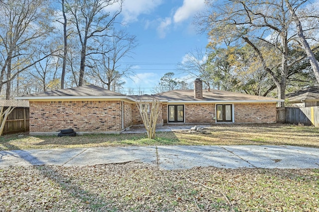 rear view of property with a lawn