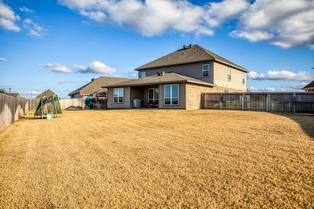 back of property featuring a yard