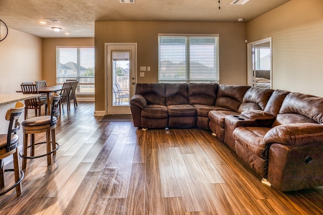 living room featuring hardwood / wood-style floors and a textured ceiling