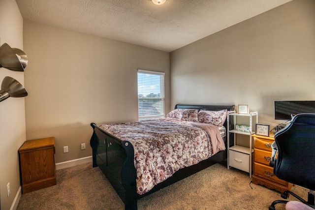 bedroom featuring a textured ceiling and carpet