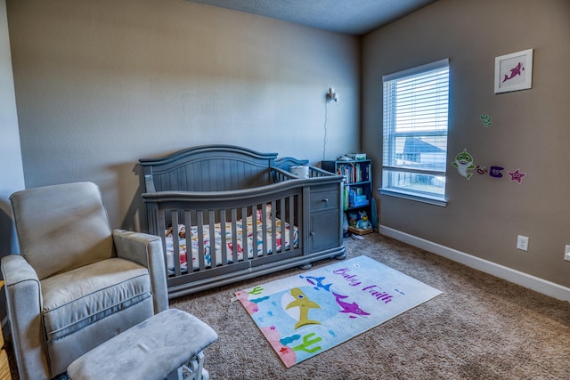 carpeted bedroom with a nursery area