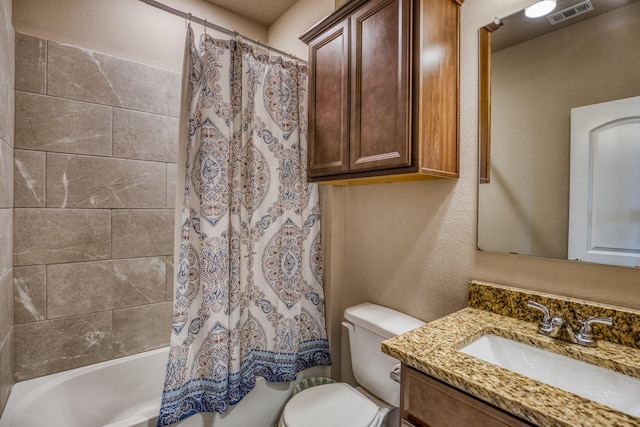 full bathroom featuring vanity, shower / bath combination with curtain, and toilet