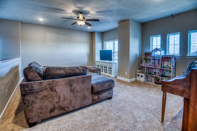 carpeted living room featuring ceiling fan and a textured ceiling