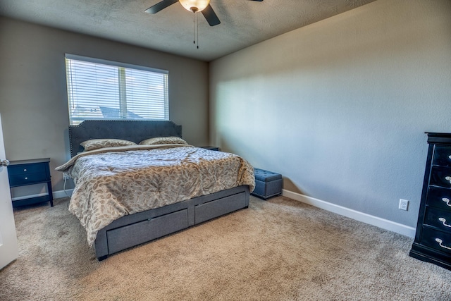 carpeted bedroom with ceiling fan and a textured ceiling