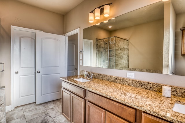 bathroom featuring vanity and an enclosed shower