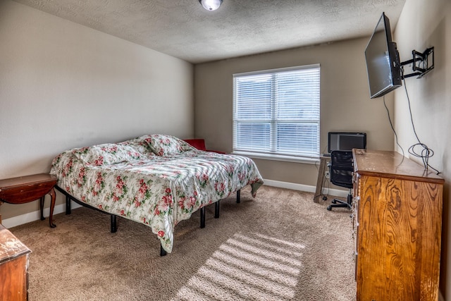 carpeted bedroom featuring a textured ceiling