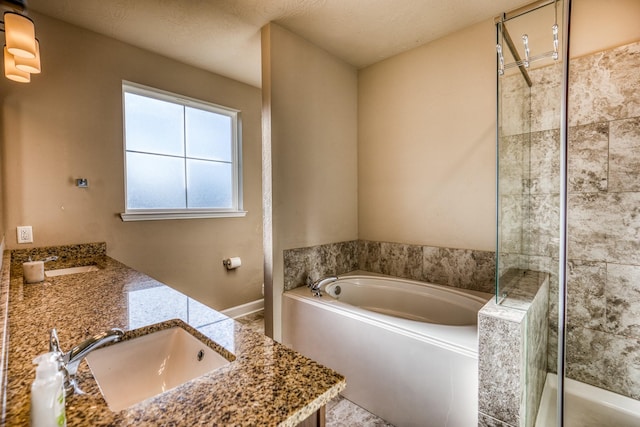 bathroom featuring shower with separate bathtub and vanity