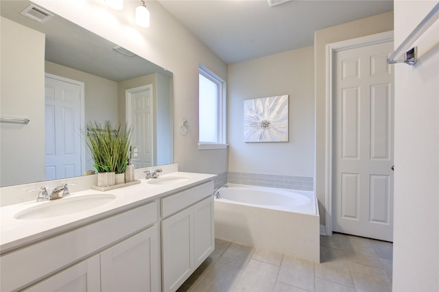 bathroom featuring vanity, a tub, and tile patterned floors