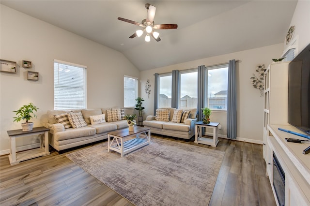 living room featuring ceiling fan, a healthy amount of sunlight, vaulted ceiling, and hardwood / wood-style floors