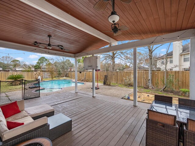 wooden deck featuring a fenced in pool, an outdoor hangout area, and ceiling fan