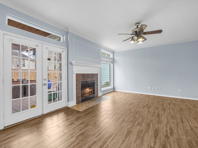 unfurnished living room with crown molding, wood-type flooring, and ceiling fan