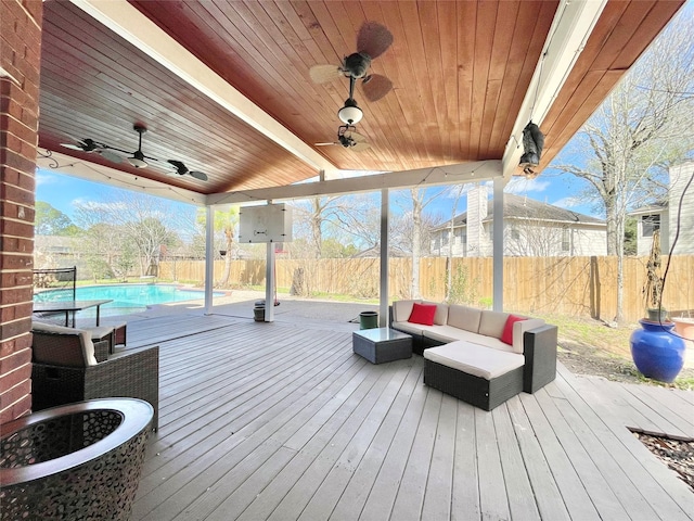 wooden deck with a fenced in pool, a fenced backyard, outdoor lounge area, and a ceiling fan