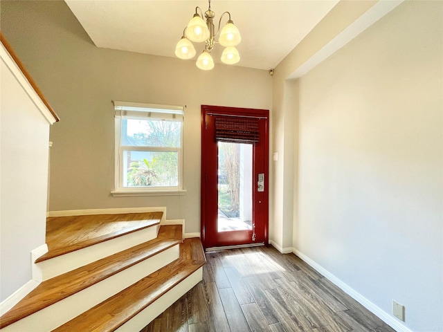 entryway featuring an inviting chandelier and dark hardwood / wood-style floors