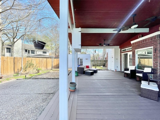 wooden terrace with an outdoor hangout area, an outbuilding, and ceiling fan