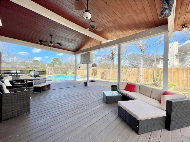 wooden deck with a fenced in pool, an outdoor living space, and ceiling fan