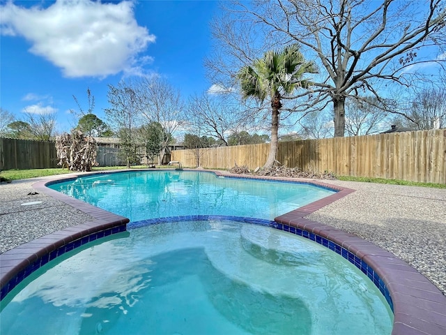 view of swimming pool featuring an in ground hot tub