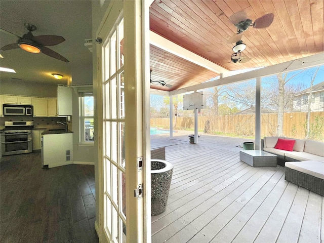 deck featuring sink, an outdoor hangout area, and ceiling fan