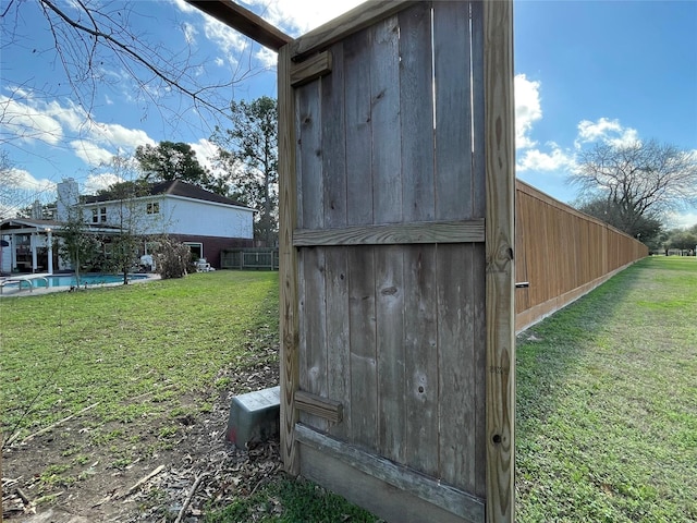 view of outbuilding with a fenced in pool