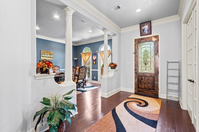 entryway with crown molding, dark hardwood / wood-style floors, and decorative columns