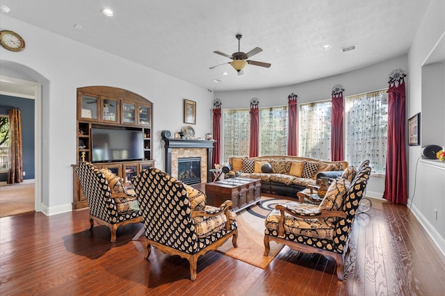 living room with hardwood / wood-style floors, a fireplace, and ceiling fan