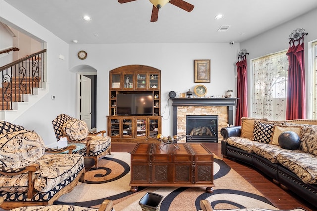 living room with hardwood / wood-style floors, a fireplace, and ceiling fan