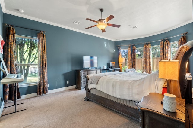 carpeted bedroom featuring crown molding and ceiling fan