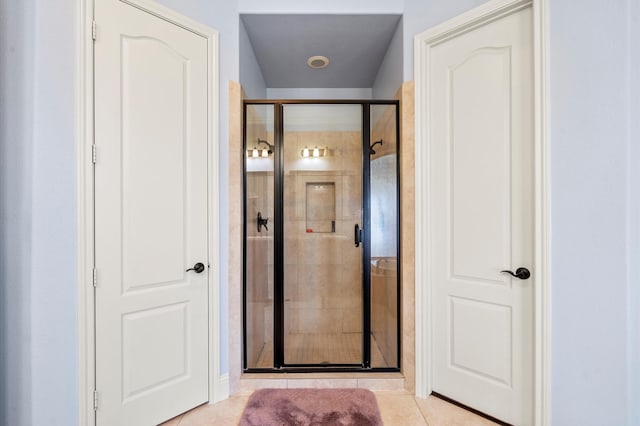 bathroom with tile patterned floors and an enclosed shower