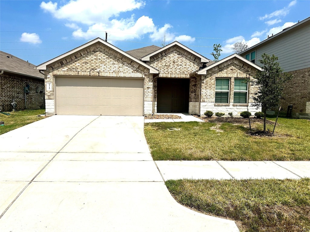 view of front of house with a garage and a front yard